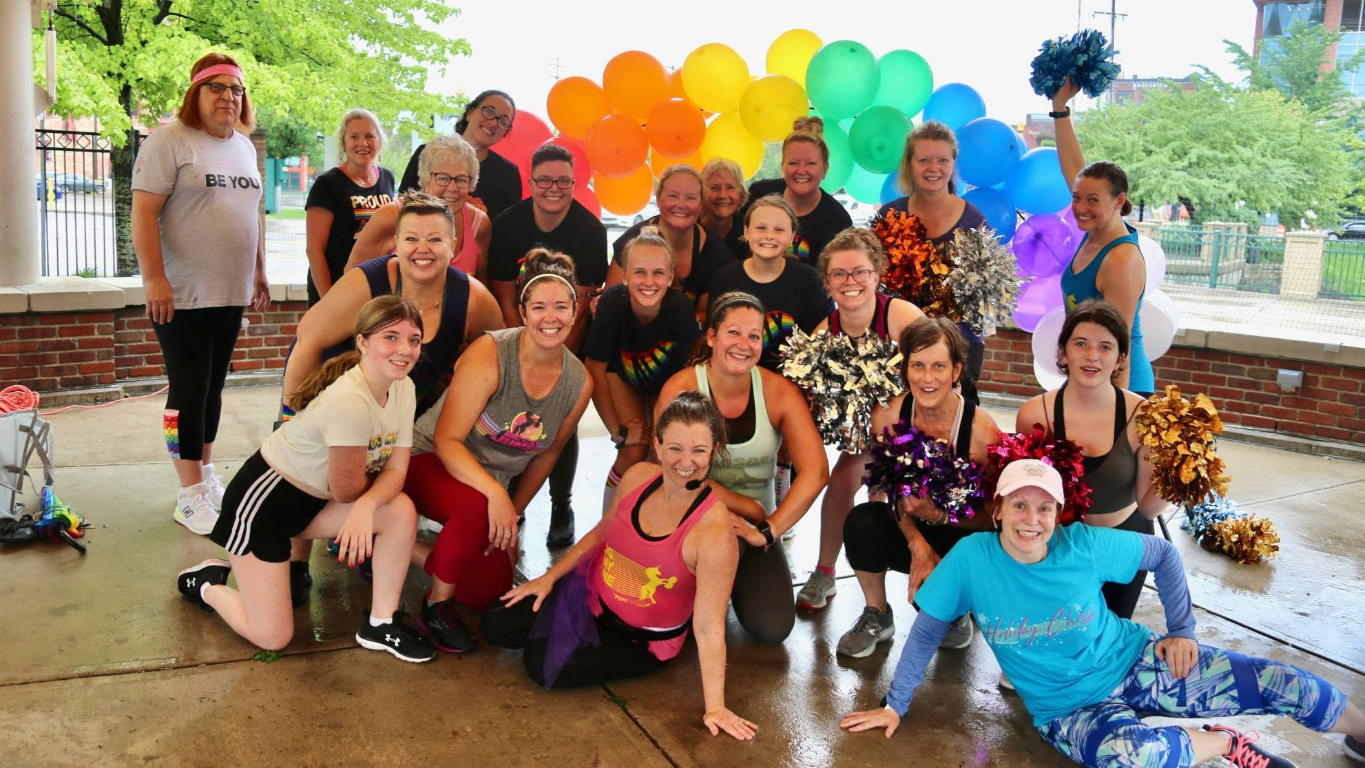 Heather with a group of instructors and volunteers at a Pride-themed community fitness fundraiser